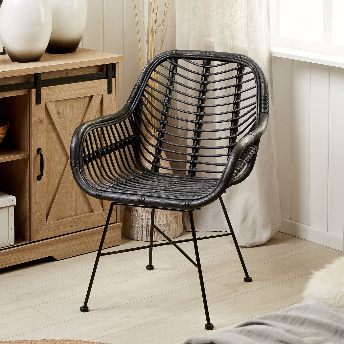 Black Rattan Armchair With Wicker Detailing And Black Metal Legs For Living Room